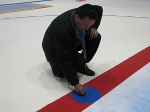 Lewis Staats places the Indian Head Nickel at center ice