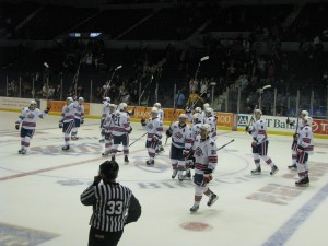 Amerks raise their sticks at center ice after the win
